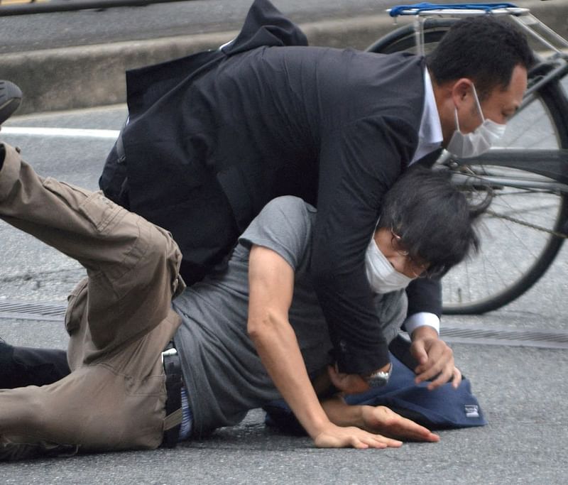 A man, believed to be a suspect shooting former Japanese Prime Minister Shinzo Abe is held by police officers at Yamato Saidaiji Station in Nara, Nara Prefecture on 8 July, 2022.