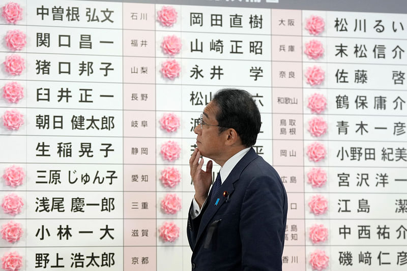 Japan’s prime minister and the president of the Liberal Democratic Party (LDP) Fumio Kishida watches after placing a red paper rose on a LDP candidate’s name to indicate the victory in the upper house election, at the party’s headquarters in Tokyo on 10 July, 2022.