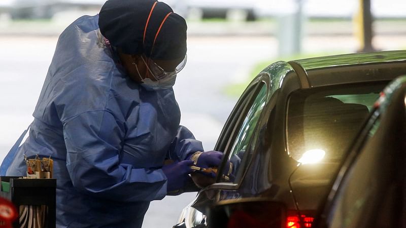 A staff member of the Westchester Medical Center applies a monkeypox vaccine to a person in a drive-through monkeypox vaccination point at the Westchester Medical Center in Valhalla, New York, US, on 28 July 2022