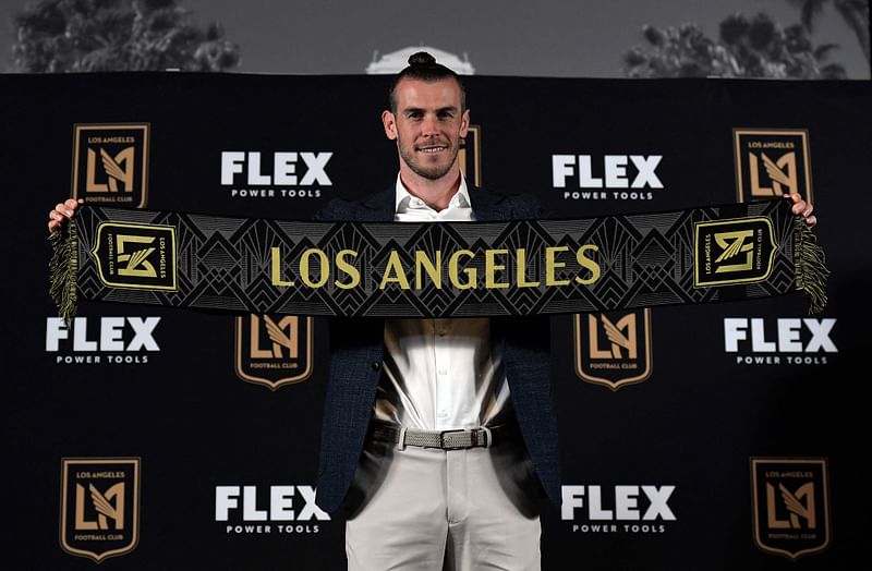 In this file photo taken on July 11, 2022, forward Gareth Bale holds the Los Angeles Football Club scarf during a news conference after he was introduced at Banc of California Stadium in Los Angeles, California. Wales captain Gareth Bale got his first taste of Major League Soccer action on 17 July, 2022