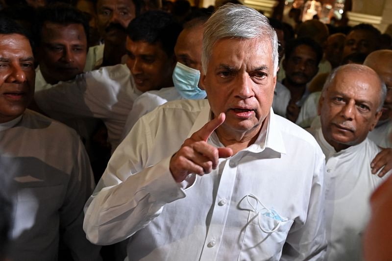 Sri Lanka's newly elected president Ranil Wickremesinghe addresses the media representatives during his visit at the Gangaramaya Buddhist temple in Colombo on 20 July, 2022