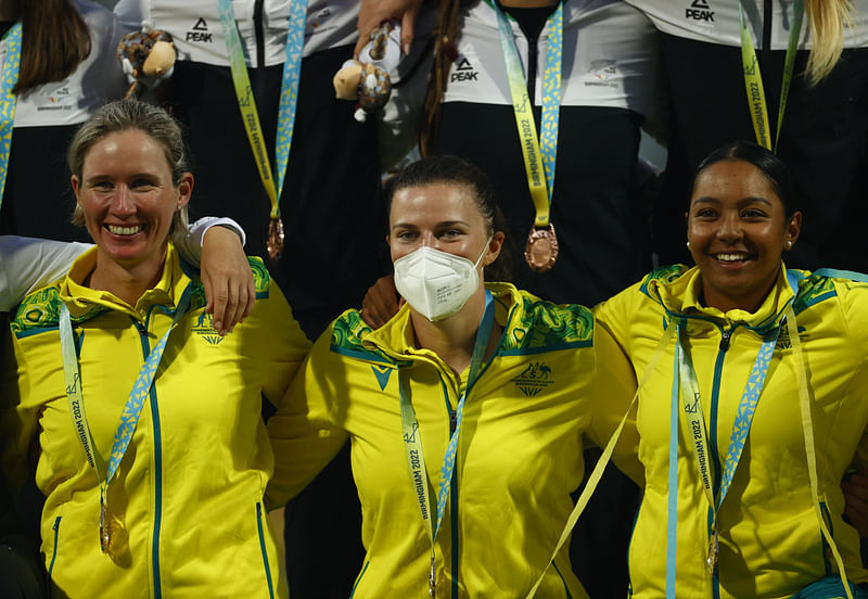 Gold medallists Australia's Beth Mooney, Tahlia McGrath (C) and Alana King celebrate on the podium during the medal ceremony of the cricket discipline in the Commonwealth Games at the Edgbaston Stadium, Britain on 7 August, 2022