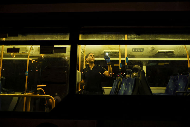 An Israeli police officer checks a bus following an incident in Jerusalem on 14 August, 2022