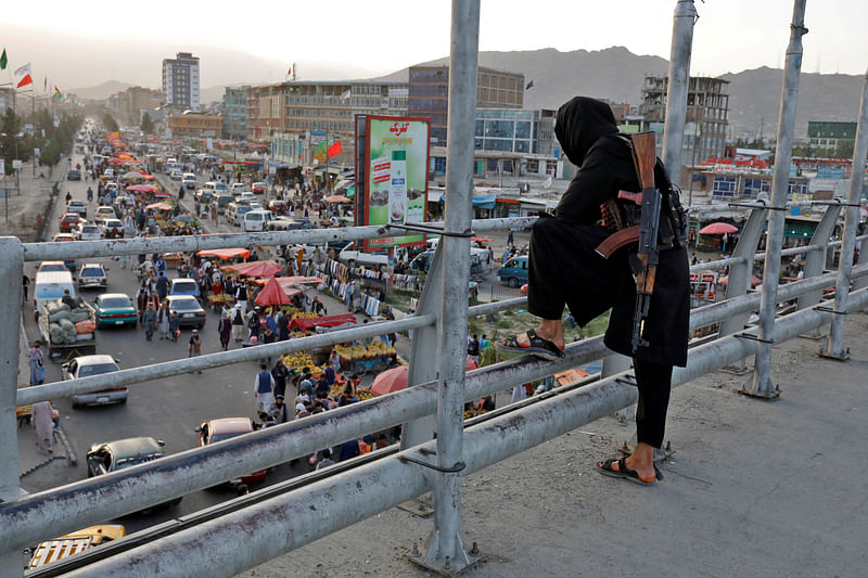 A Taliban fighter stands guard on a bridge in Kabul, Afghanistan, on 6 August, 2022