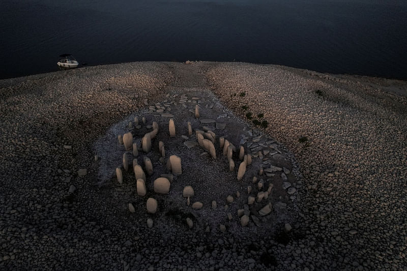 The dolmen of Guadalperal, also known as the Spanish Stonehenge, is seen due to the receding waters of the Valdecanas reservoir in the outskirts of El Gordo, Spain on 3 August, 2022