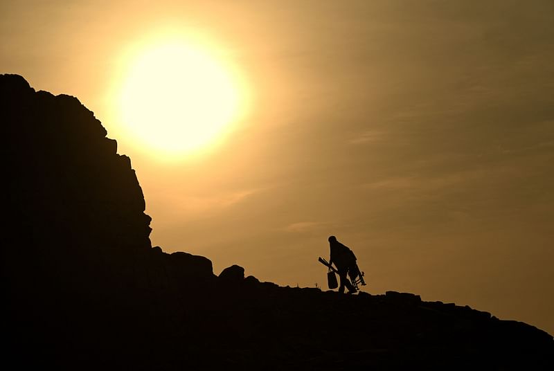 A fisherman walks by the banks of China's largest freshwater Poyang Lake in Juijiang amid scorching heat, China's central Jiangxi province on 23 August, 2022