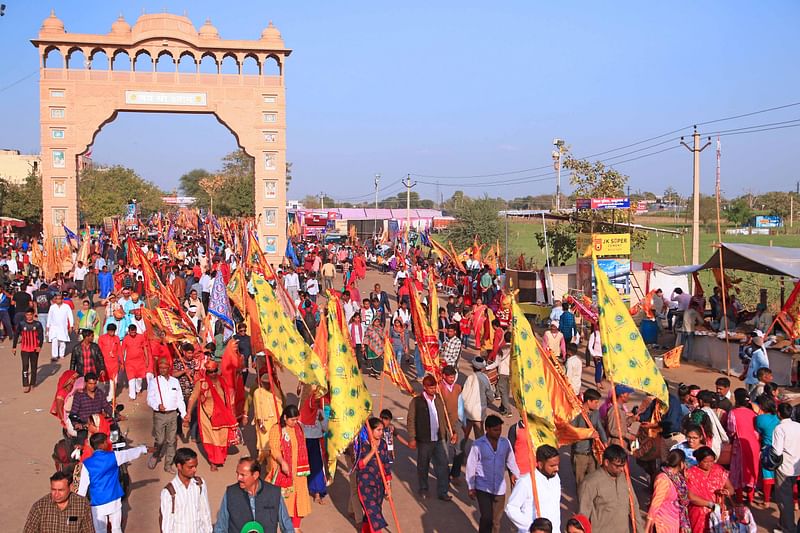 Devotees with religious flags arrives to participate annual 10 days fair at Khatu Shyam Ji Temple on the eve of Fagun month according to hindu calender at Sikar in Rajasthan on Saturday.