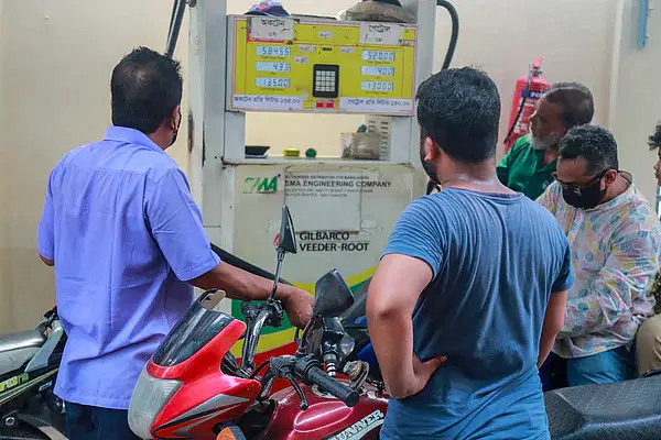 People gazing at the metre while buying petrol from a station