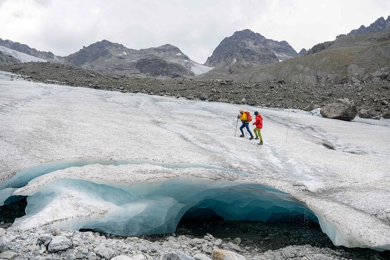 Glaciologists Andrea Fischer (L) and Violeta Lauria from the Austrian Academy of Sciences walk on the Jamtal Glacier (Jamtalferner) near Galtuer, Tyrol, Austria on 20 July, 2022