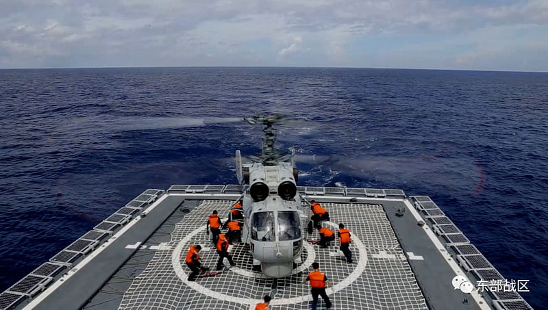 A Navy Force helicopter under the Eastern Theatre Command of China's People's Liberation Army (PLA) takes part in military exercises in the waters around Taiwan, at an undisclosed location on 8 August, 2022 in this handout picture released on 9 August, 2022.