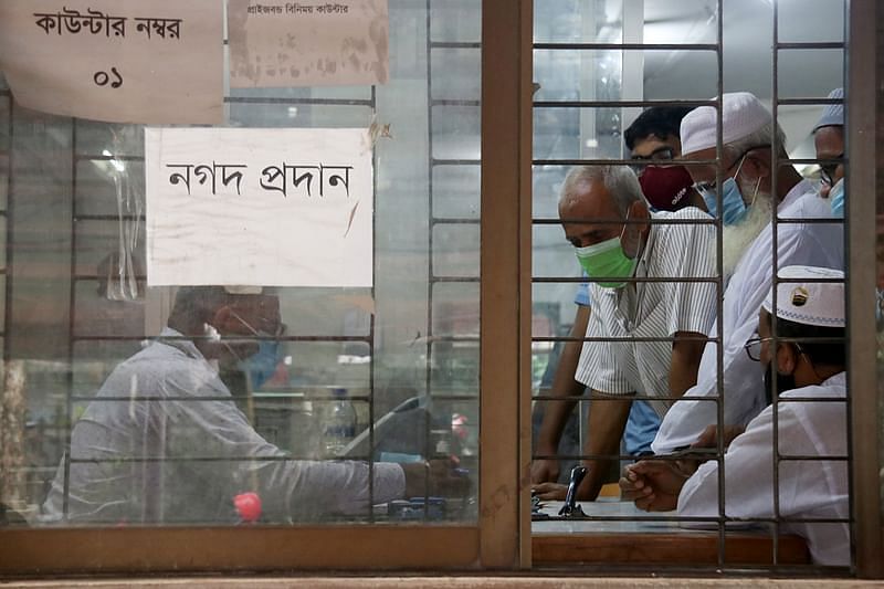 Photo shows customers receiving services at a bank.