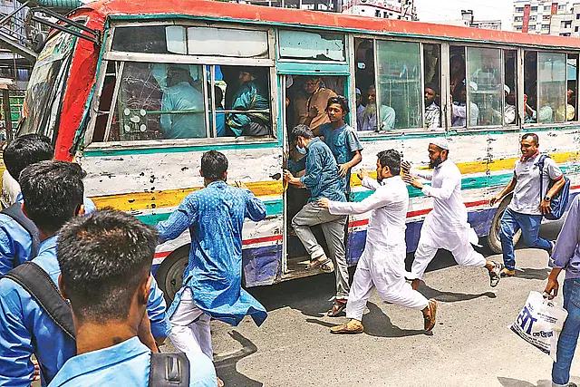 People run for a bus near the Karwan Bazar area of the capital