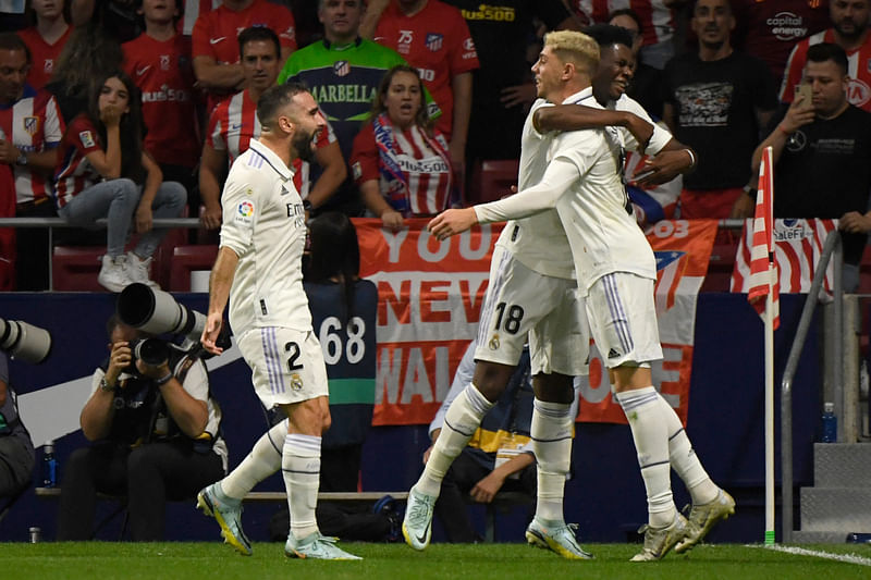 Real Madrid's players celebrate after the team second goal during the Spanish League football match between Club Atletico de Madrid and Real Madrid CF at the Wanda Metropolitano stadium in Madrid on 18 September, 2022.