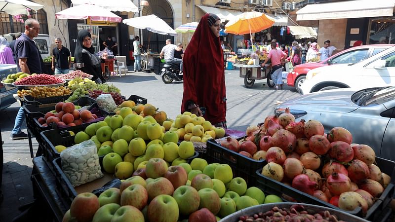 A woman walks at a market in the southern Lebanese city of Sidon, Lebanon on 6 September, 2022