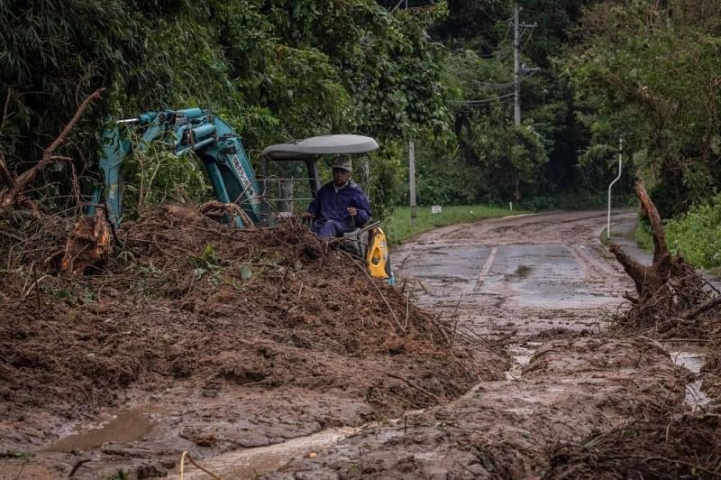 A worker clears debris and mud at the site of a landslide caused by Typhoon Nanmadol in Mimata, Miyazaki prefecture on 19 September, 2022.