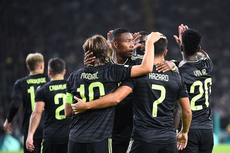 Real Madrid's Croatian midfielder Luka Modric (L) celebrates after scoring his team second goal during the UEFA Champions League Group F football match between Celtic and Real Madrid, at the Celtic Park stadium, in Glasgow, on 6 September, 2022