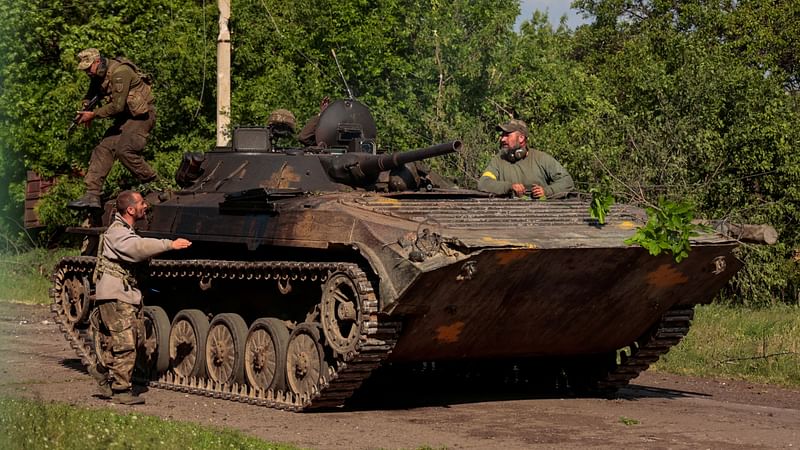 Ukrainian servicemen are seen atop an armoured fighting vehicle near a frontline, as Russia's invasion on Ukraine continues, in Donetsk Region, Ukraine 28 May 2022.