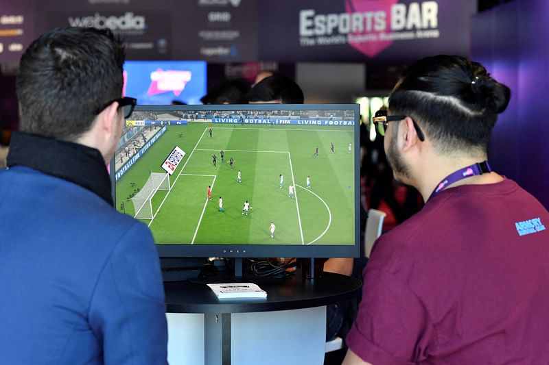 This file photo taken on 13 February, 2019, shows visitors playing on EA Vancouver video game developer's football simulation video game FIFA 19 at the eSports Bar trade fair in Cannes, southern France