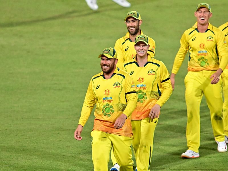 Australia's captain Aaron Finch escorts his team off the field after winning the third ODI between Australia and New Zealand at the Cazalys Stadium in Cairns on 11 September, 2022