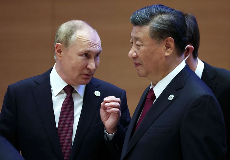 Russian president Vladimir Putin speaks to China's president Xi Jinping during the Shanghai Cooperation Organisation leaders' summit in Samarkand on 16 September, 2022