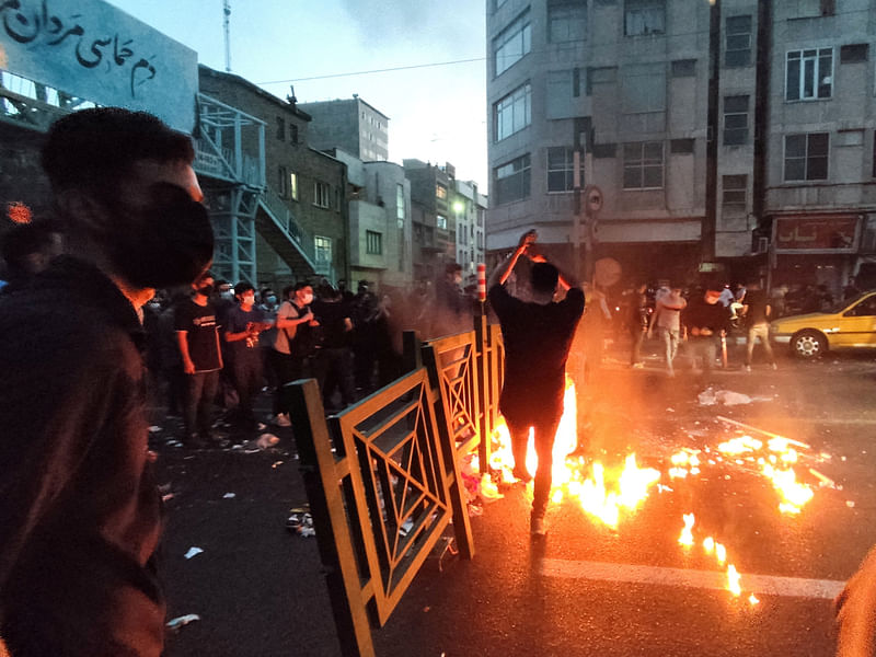 People light a fire during a protest over the death of Mahsa Amini, a woman who died after being arrested by the Islamic republic's "morality police", in Tehran, Iran on 21 September, 2022