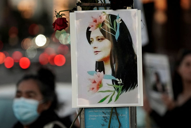 An image of Mahsa (Zhina) Amini, an Iranian Kurdish woman, is displayed on a pole during a protest following her death, in Los Angeles, California, US, 22 September, 2022.