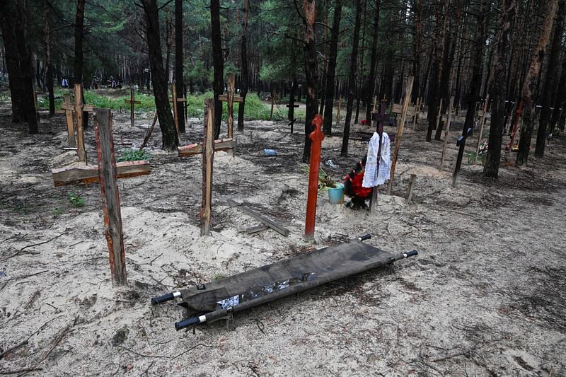 A photo shows crosses at a burial site in a forest on the outskirts of Izyum, on 17 September, 2022