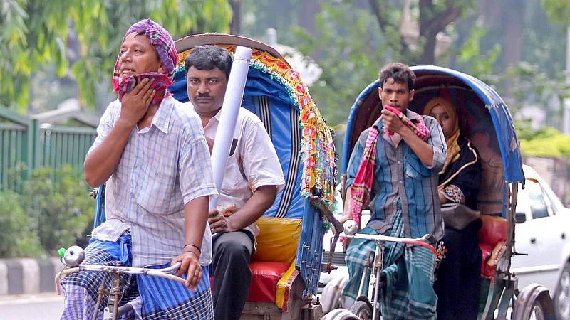 Rickshaw pullers sweat in high temperature in Dhaka