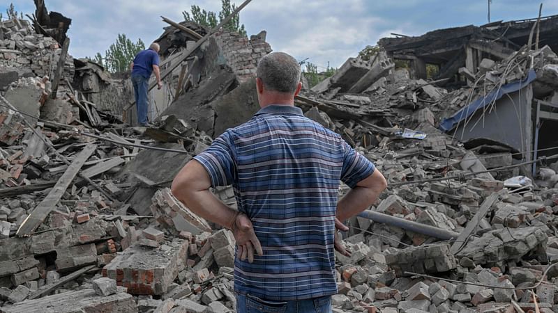 A local resident looks at the rubble of a destroyed building in Toretsk, eastern Ukraine, on 5 August, 2022, amid the Russian invasion of Ukraine