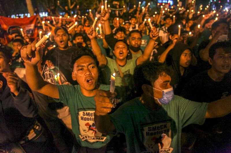 Football supporters hold candlelight vigil for victims of a stampede, in Medan on 3 October, 2022