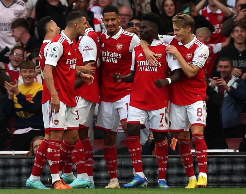 Arsenal's English midfielder Bukayo Saka (2R) celebrates scoring the team's second goal during the English Premier League football match between Arsenal and Liverpool at the Emirates Stadium in London on 9 October, 2022