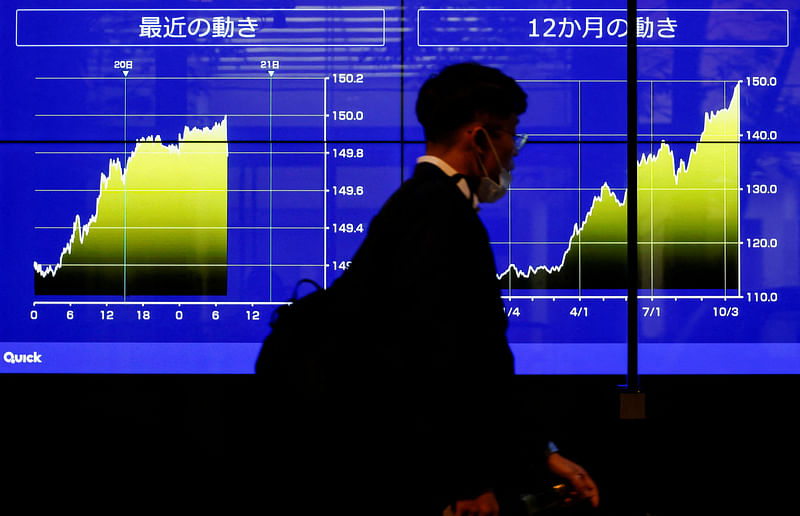 A passerby walks past an electric monitor displaying the graph of recent movements on Japanese yen exchange rate against the U.S. dollar in Tokyo, Japan, October 20, 2022