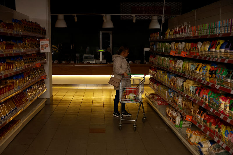 A woman shops in a supermarket as Kharkiv suffers an electricity outage, amid Russia's attack on Ukraine, in Kharkiv, Ukraine, October 17, 2022