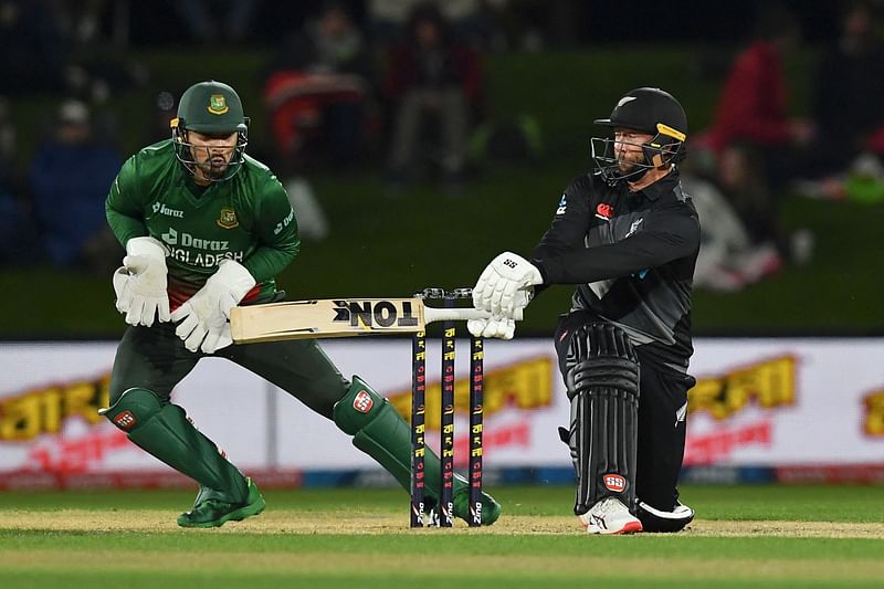 New Zealand's Devon Conway is watched by Bangladesh's Nurul Hasan as he plays a shot during the third cricket match between New Zealand and Bangladesh of the Twenty20 tri-series at Hagley Oval in Christchurch on 9 October, 2022