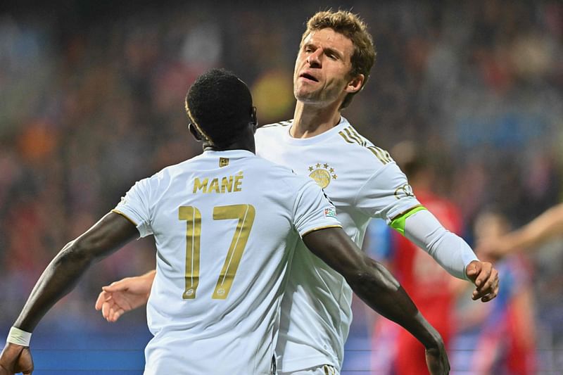 Bayern Munich's Senegalese forward Sadio Mane (L) celebrates scoring the opening goal with his teammate Bayern Munich's German forward Thomas Mueller during the UEFA Champions League Group C football match between FC Viktoria Plzen and FC Bayern Munich in Plzen, Czech Republic, on 12 October, 2022