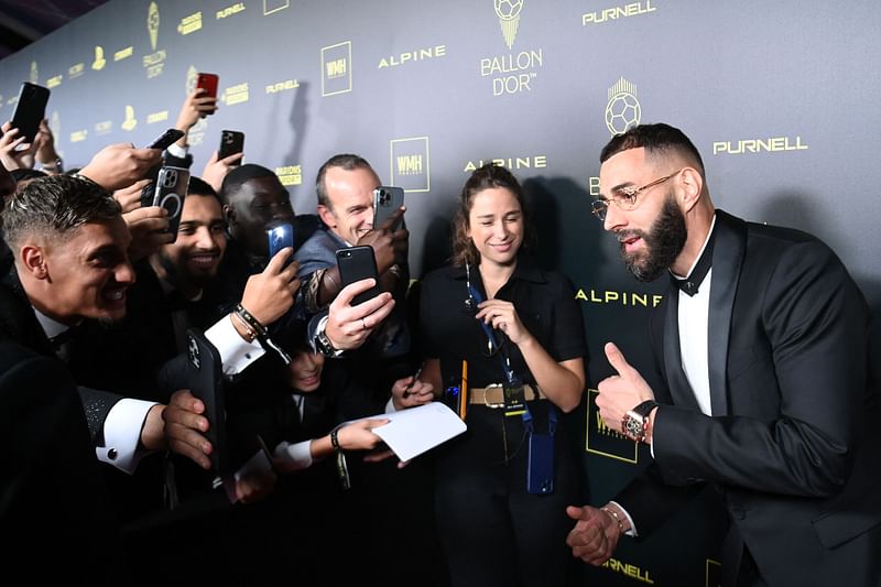 Real Madrid's French forward Karim Benzema poses with fans upon arrival to attend the 2022 Ballon d'Or France Football award ceremony at the Theatre du Chatelet in Paris on 17 October, 2022