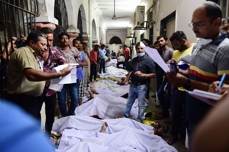 Bodies are seen on the floor of the government civil hospital after a bridge across the river Machchhu collapsed in Morbi, some 220 kms from Ahmedabad, early on 31 October, 2022