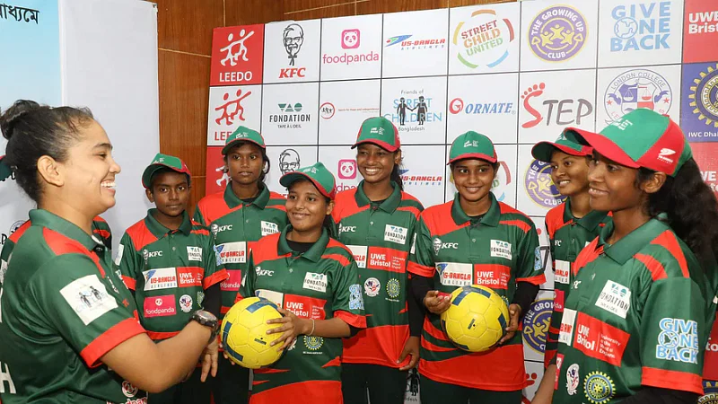 The Bangladesh Street child football team players all smiles with coach Nazma Akhter (L)