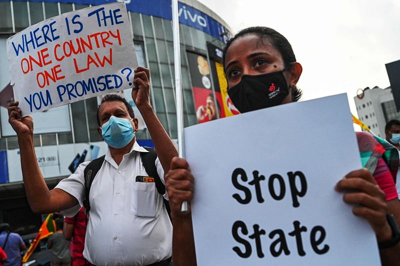 Protestors hold placards during an anti-government demonstration in Colombo on 7 October, 2022