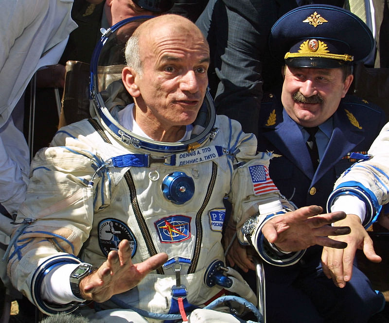 In this file photo taken on May 06, 2001 US space tourist Dennis Tito (L) speaks to the press after his landing near the Kazakh town of Arkalyk (some 300 km from Astana). Dennis Tito, an American entrepreneur who in 2001 became the first person to pay for their own space voyage