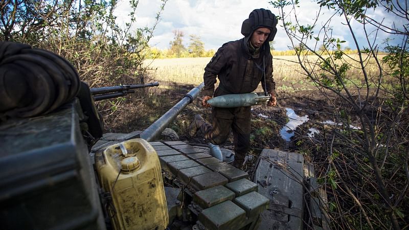 A Ukrainian service member carries a shell to a tank at a position near a frontline, amid Russia's attack on Ukraine, outside the town of Bakhmut, Donetsk region, Ukraine on 4 October, 2022