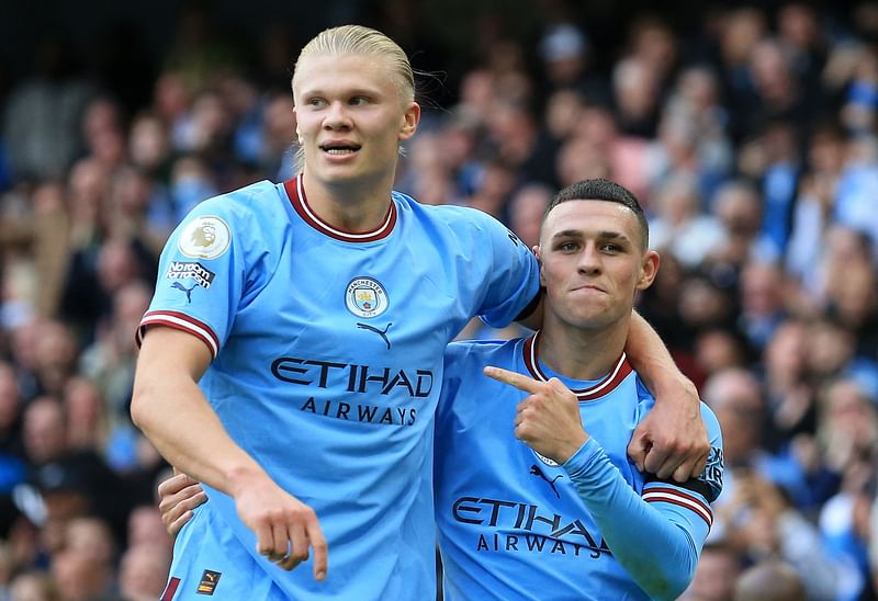 Manchester City's English midfielder Phil Foden (R) celebrates scoring his team's sixth goal and his third with Manchester City's Norwegian striker Erling Haaland (L) during the English Premier League football match between Manchester City and Manchester United at the Etihad Stadium in Manchester, north west England, on 2 October, 2022