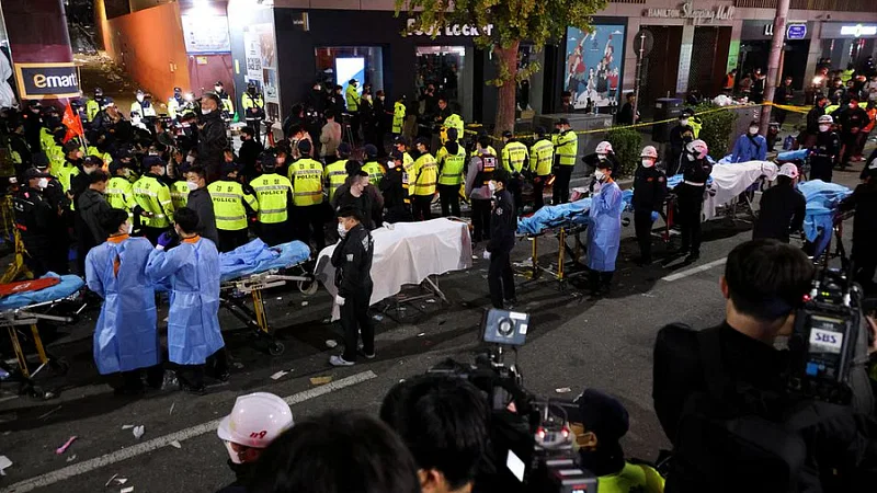 Rescue workers recovering the bodies of those killed in the Halloween stampede in Seoul, South Korea on 29 October, 2022