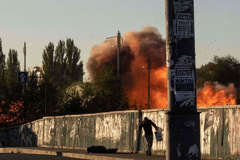 A man falls is seen on the ground after a blast following a drone attack in Kyiv on 17 October, 2022, amid the Russian invasion of Ukraine