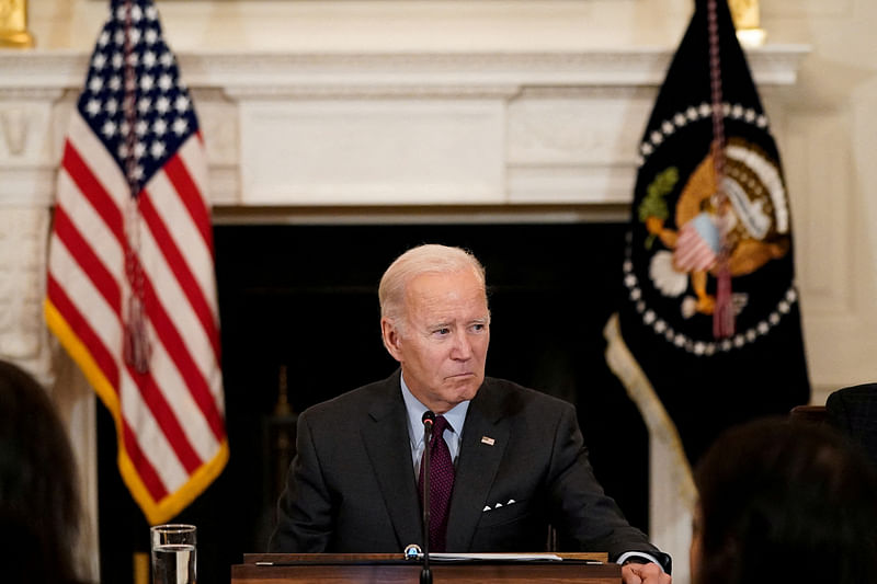 US President Joe Biden listens to a guest speak during a meeting in the State Dining Room at the White House in Washington, US on 4 October, 2022