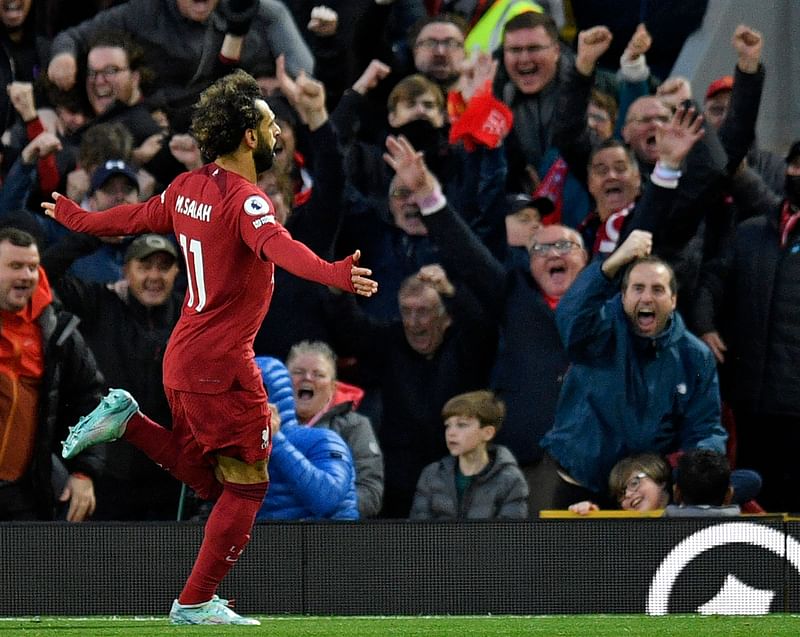 Liverpool's Egyptian striker Mohamed Salah (L) celebrates after scoring the opening goal during the English Premier League football match between Liverpool and Manchester City at Anfield in Liverpool, north west England on 16 October, 2022