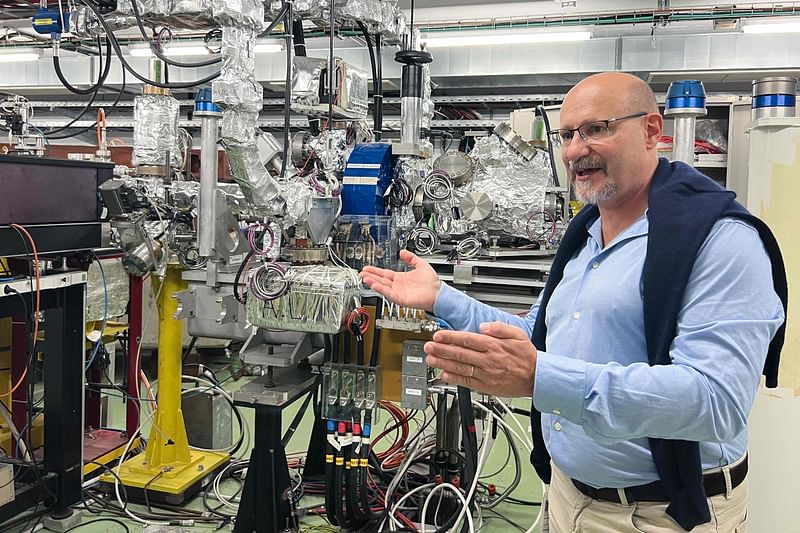 CERN Linear Electron Accelerator for Research (CLEAR) Lab facility coordinator Roberto Corsini gestures next to a 40-metre linear particle accelerator at the European Organization for Nuclear Research (CERN) in Meyrin, near Geneva on 17 October, 2022.