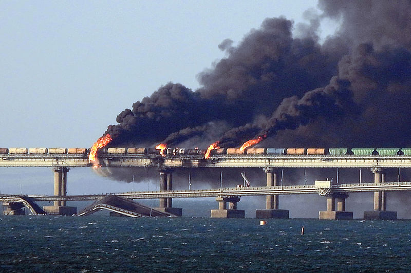 Black smoke billows from a fire on the Kerch bridge that links Crimea to Russia, after a truck exploded, near Kerch, on 8 October, 2022