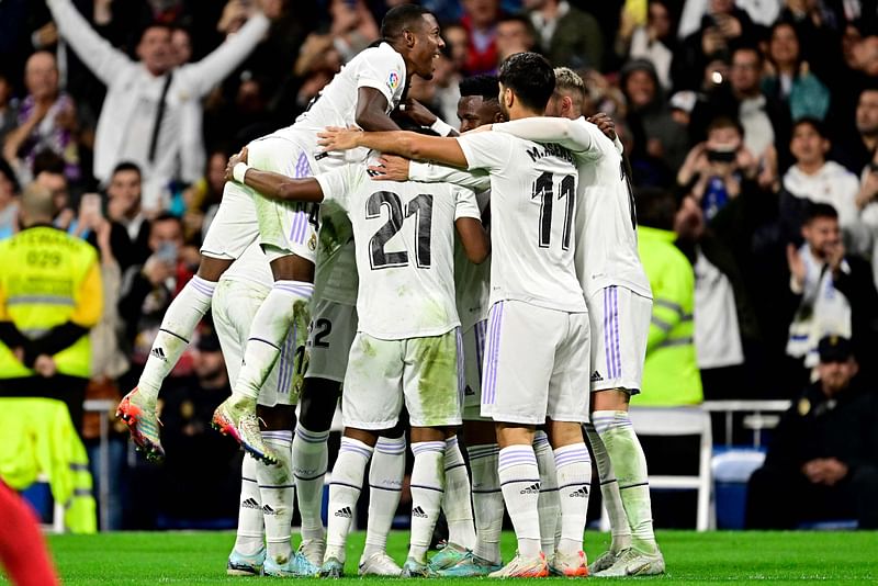 Real Madrid's Spanish forward Lucas Vazquez (C) celebrates with teammates after scoring his team's second goal during the Spanish league football match between Real Madrid CF and Sevilla FC at the Santiago Bernabeu stadium in Madrid, on 22 October, 2022