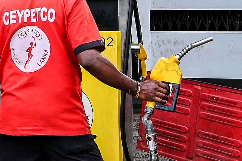 An employee fills petrol in an auto rickshaw at Ceylon petroleum corporation fuel station in Colombo on 17 October, 2022